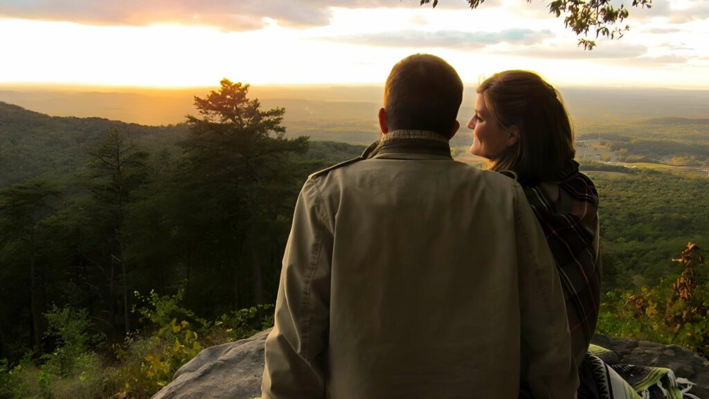 Couple Sitting Together on a Hill Top